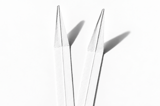 two white paper fragrance testing strips on a white background