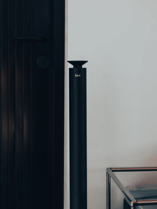 black kirri pillar diffuser standing beside a dark door frame
