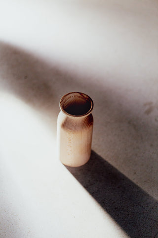 kirri wood diffuser in afternoon sun on a concrete floor
