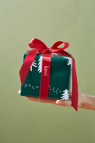 wrapped christmas gift with a red kirri ribbon
