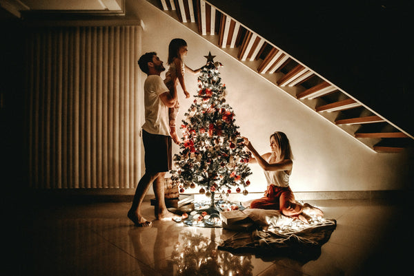 man carrying a young girl at christmas